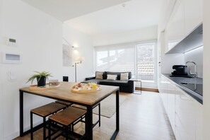Business Apartment, Balcony, City View | Living area | Flat-screen TV