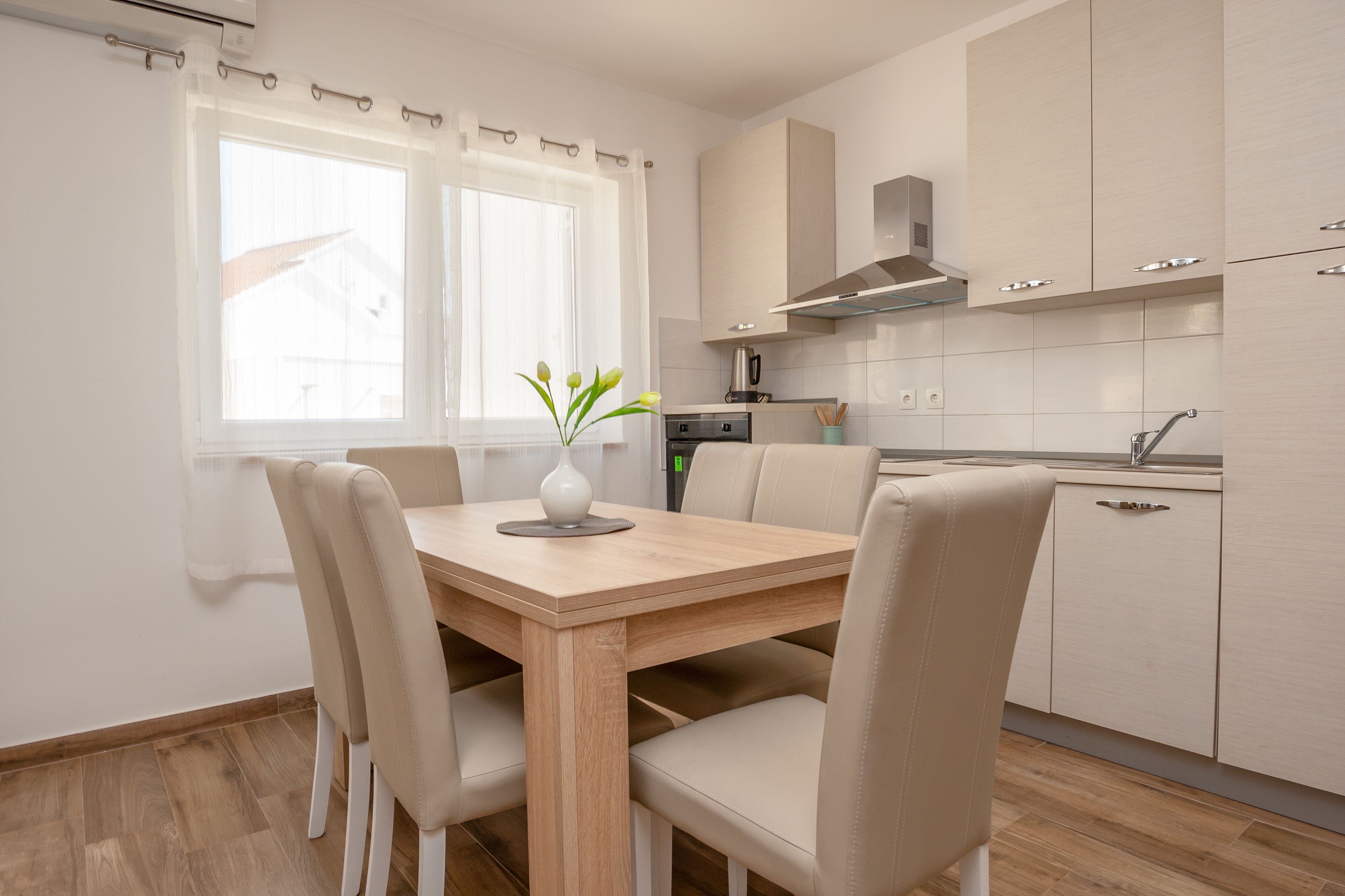 A modern kitchen with a dining area.