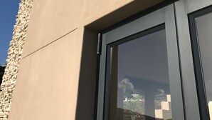 A modern building with a stone facade and a large glass window. - 11 Escape Views (Cape Town)