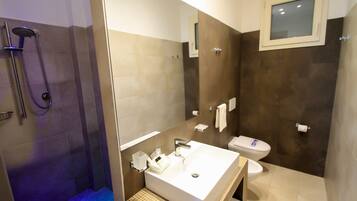 A modern bathroom with a shower, toilet, and sink.