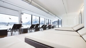 A modern hotel room with large windows, a balcony, and a view of mountains. - DORMERO BeHo Zugspitze (Biberwier)