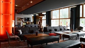 A modern lounge area with sofas, a coffee table, and a fireplace. - DORMERO BeHo Zugspitze (Biberwier)