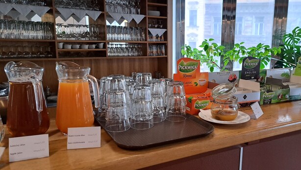 A bar area with various beverages and glassware. - Hotel Legie (Prague)