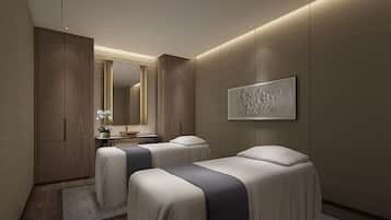 Experience a calm and sophisticated retreat with two beds, a large mirror, and a cozy seating area.