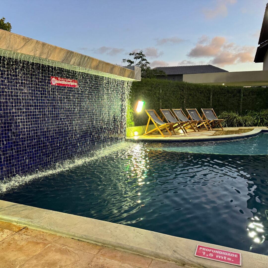 A swimming pool with a tiled wall and a depth sign indicating 1.5 meters.