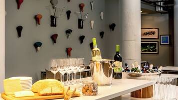 A bar area with a variety of glasses, bottles, and a cheese board.