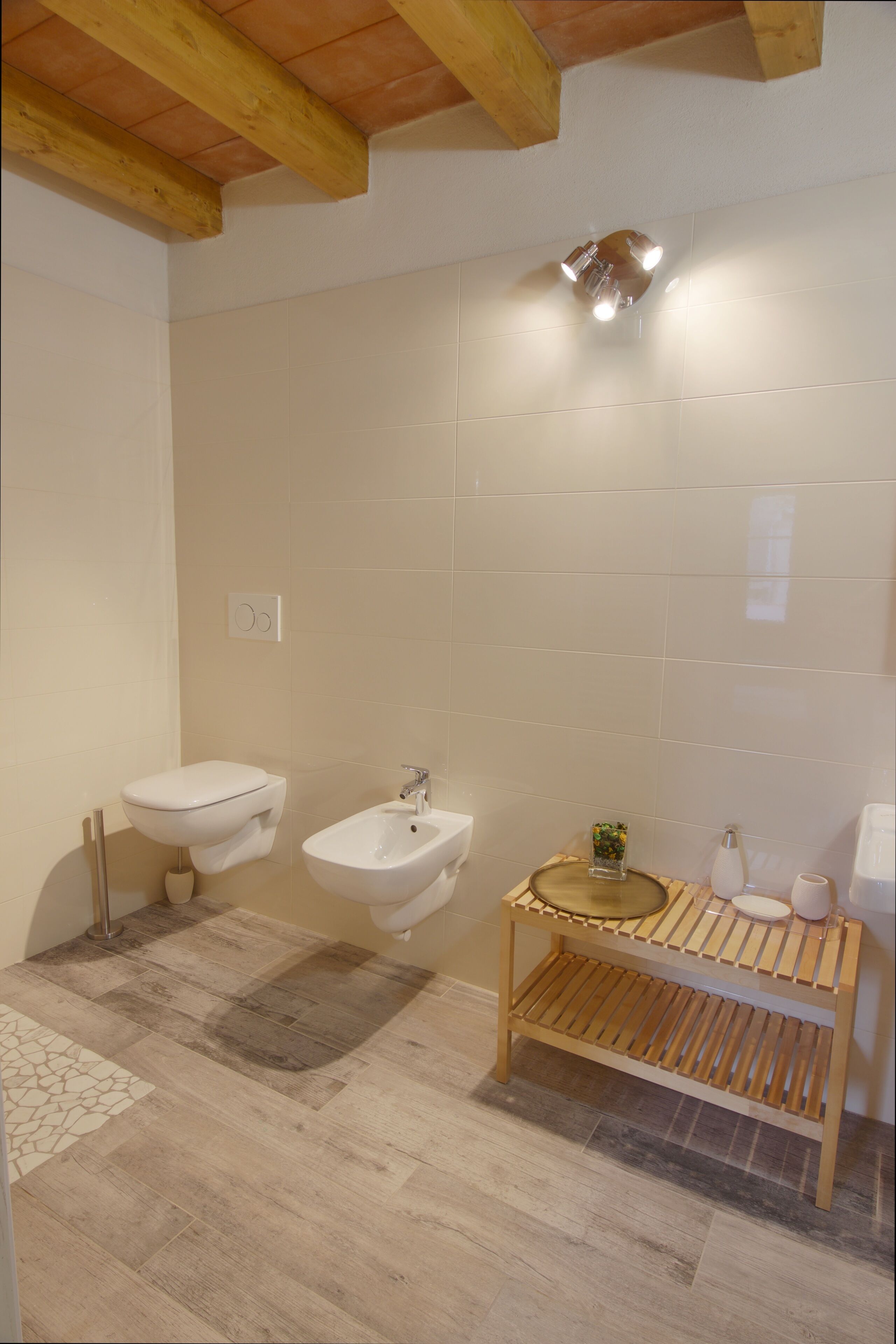 A bathroom with two sinks, a wooden vanity, and a tiled floor.