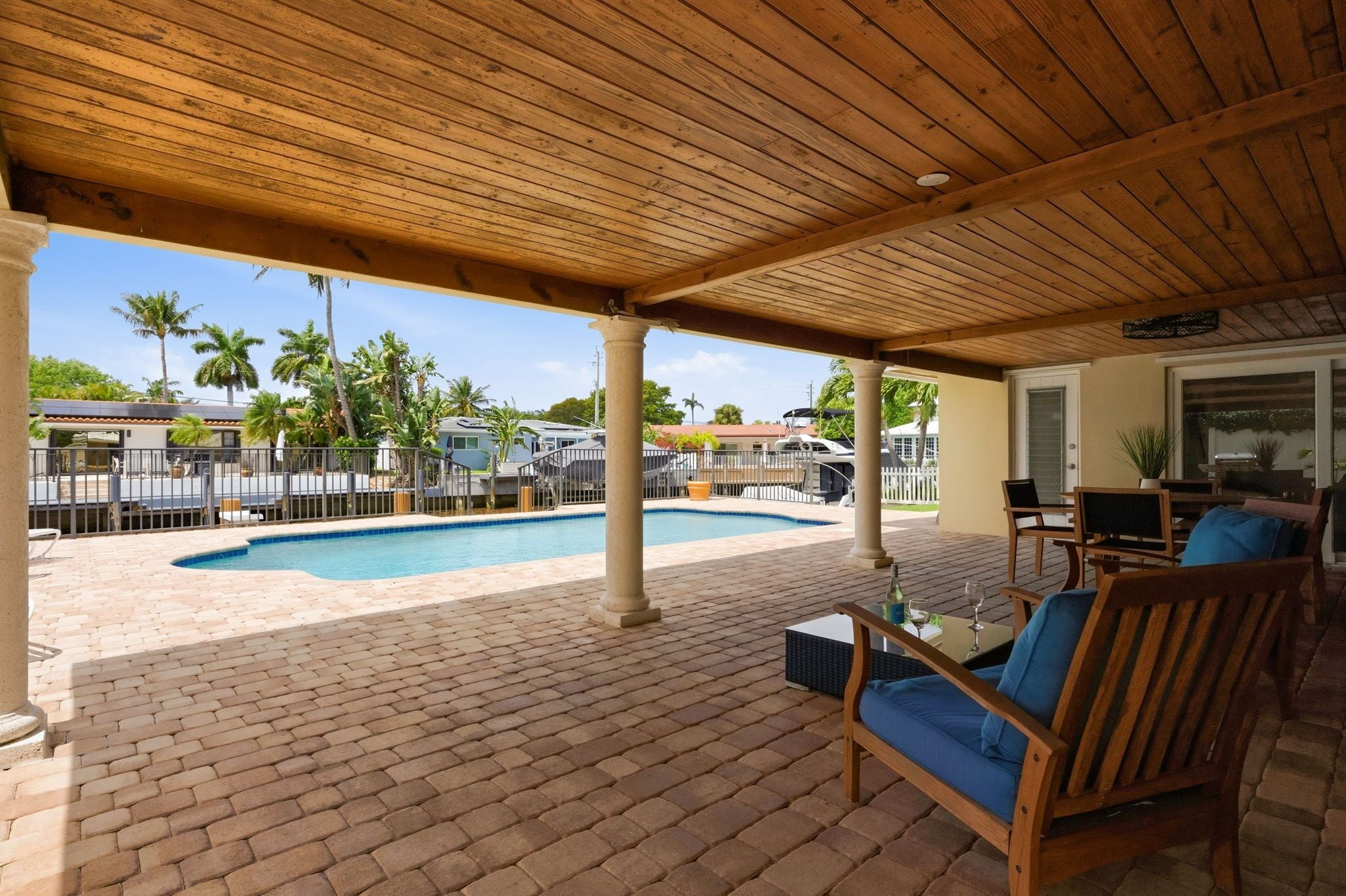Covered patio overlooking the pool and water