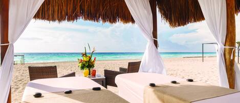 On the beach, white sand, beach cabanas, beach towels