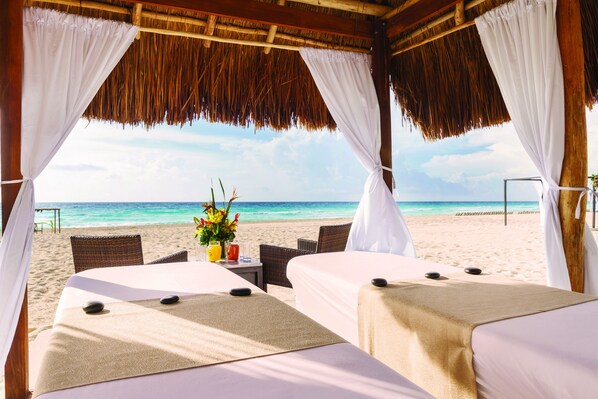 On the beach, white sand, beach cabanas, beach towels