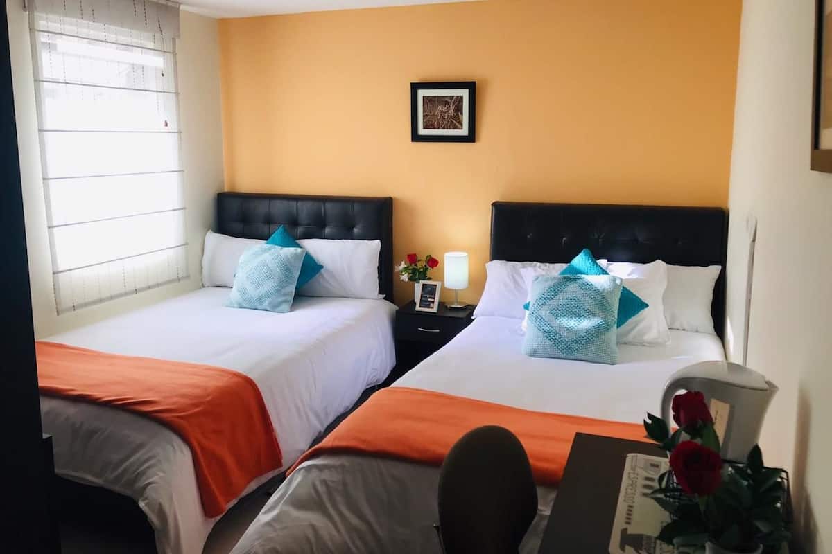 Economy Triple Room, 2 Double Beds, Private Bathroom, Tower | 1 bedroom, down comforters, desk, iron/ironing board (on request)