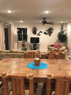 Cozy living room with a dining table, flat-screen TV, and comfortable seating for relaxation.