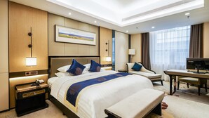 A hotel room with a large bed, bedside tables, a desk, and a television. - Qingshan Hotel Baotou（Yingbin Building） (Baotou)