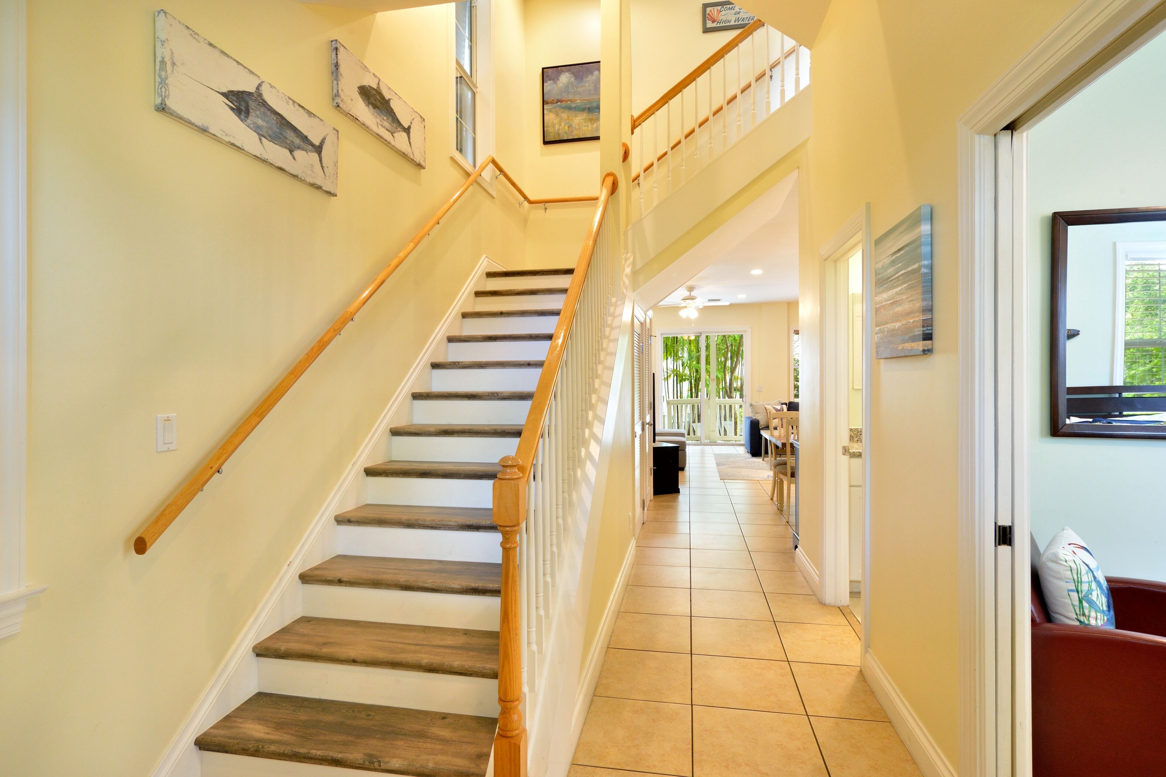 A staircase with wooden steps and a handrail, leading to a second floor.