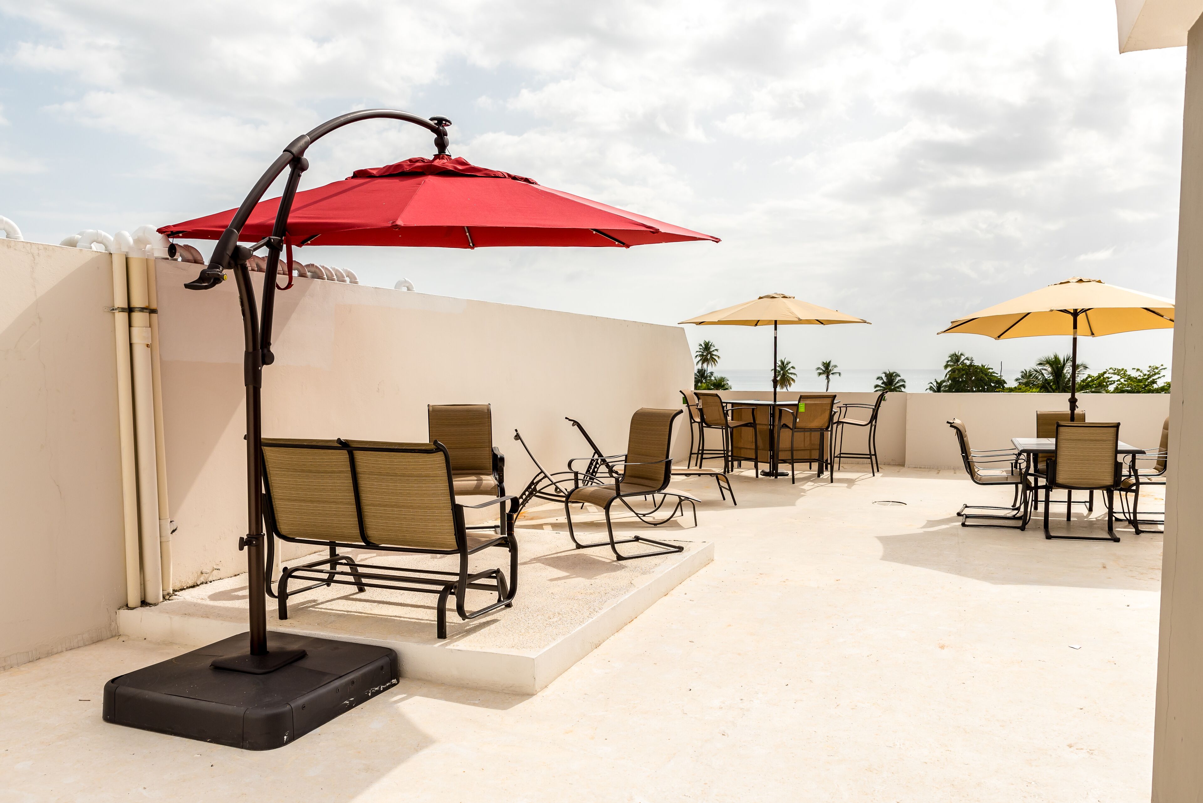 Un área de patio al aire libre con asientos y sombrillas.
