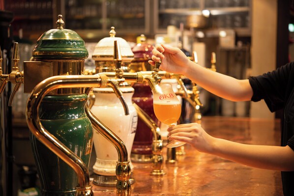 A bar with a tap and a glass of beer.