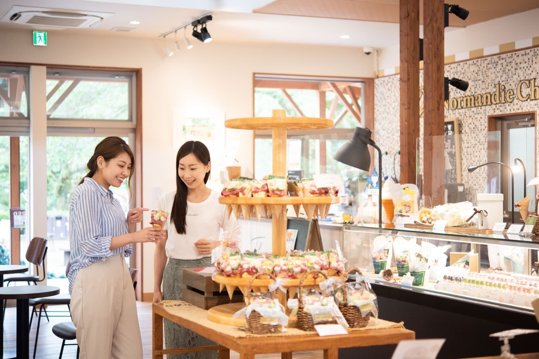 A dessert display with multiple tiers of pastries and a sign reading "Normandie Ch".