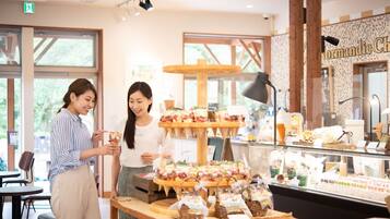 A dessert display with multiple tiers of pastries and a sign reading "Normandie Ch".