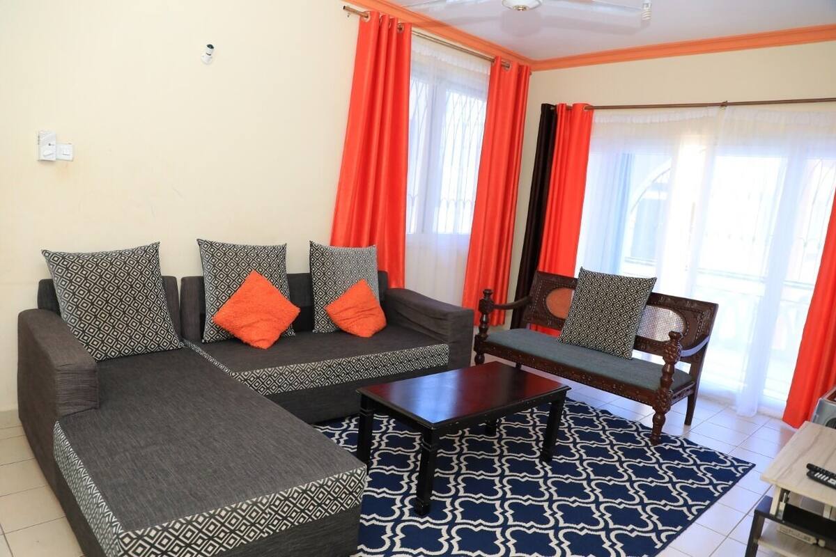 A living room with a sofa set, a coffee table, and a chair.