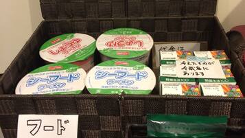 A storage box with various packaged items, including a price list and a note.
