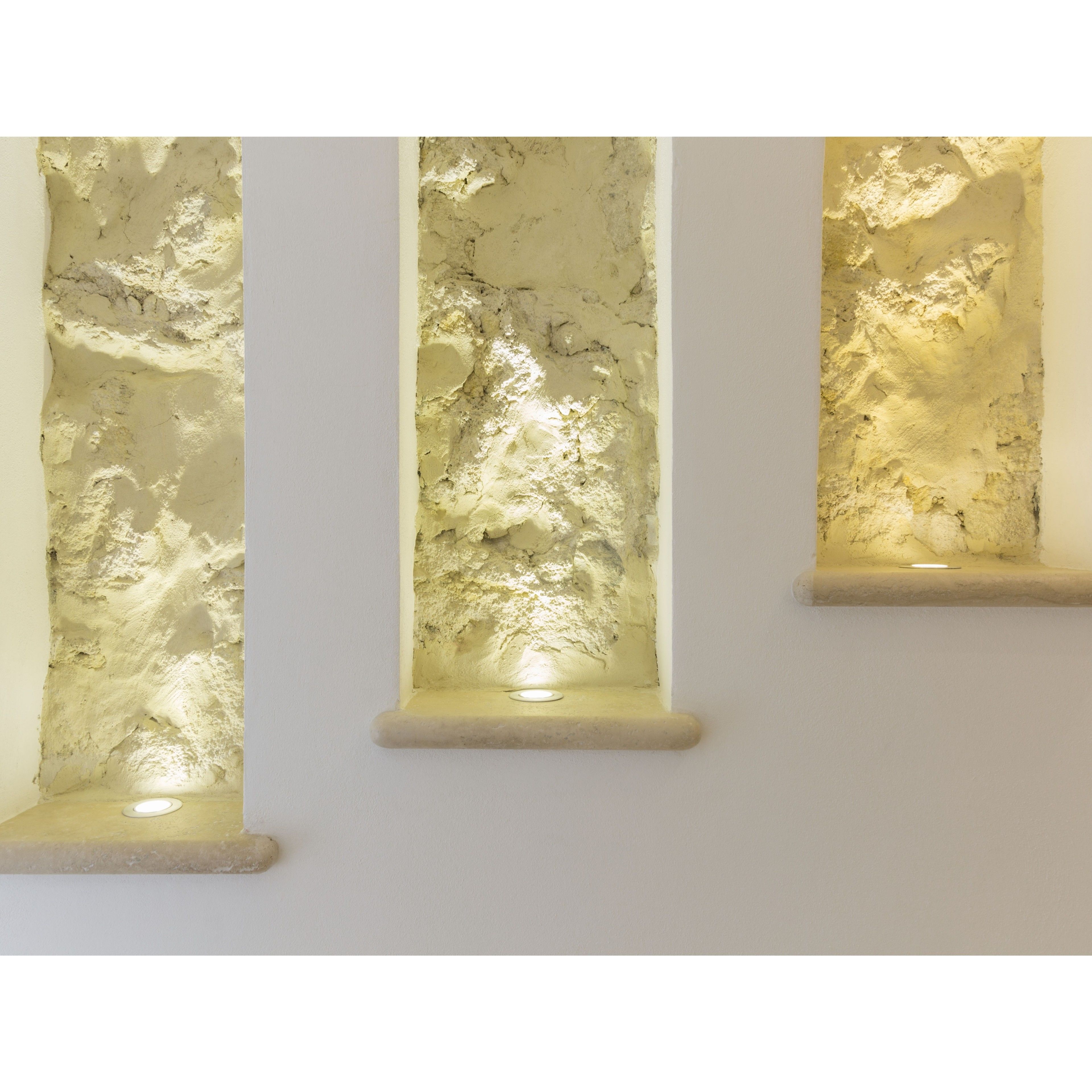 Three vertical glass panels with textured surfaces, mounted on a plain wall.