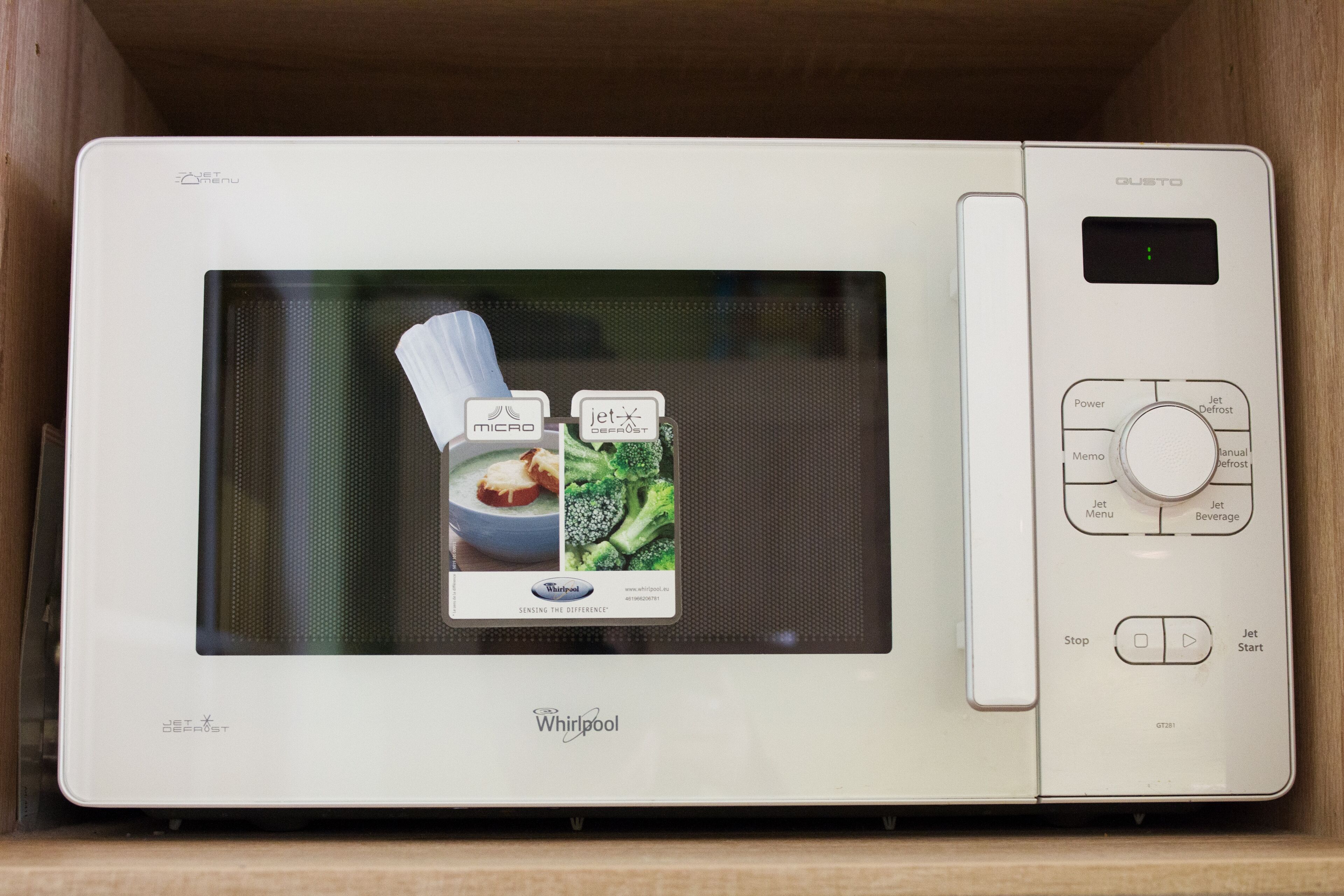 A Whirlpool microwave with a digital display and control buttons.