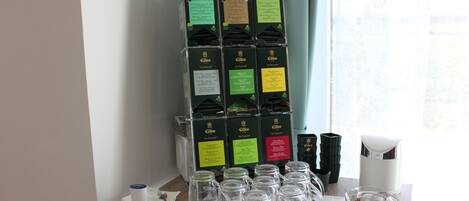 A table with wine glasses and a display of wine boxes.