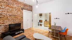 Design Apartment, 1 Bedroom (Mezzanine Bed) | Living area | Flat-screen TV, fireplace, video-game console, DVD player - Best Location Apartment (Kraków)