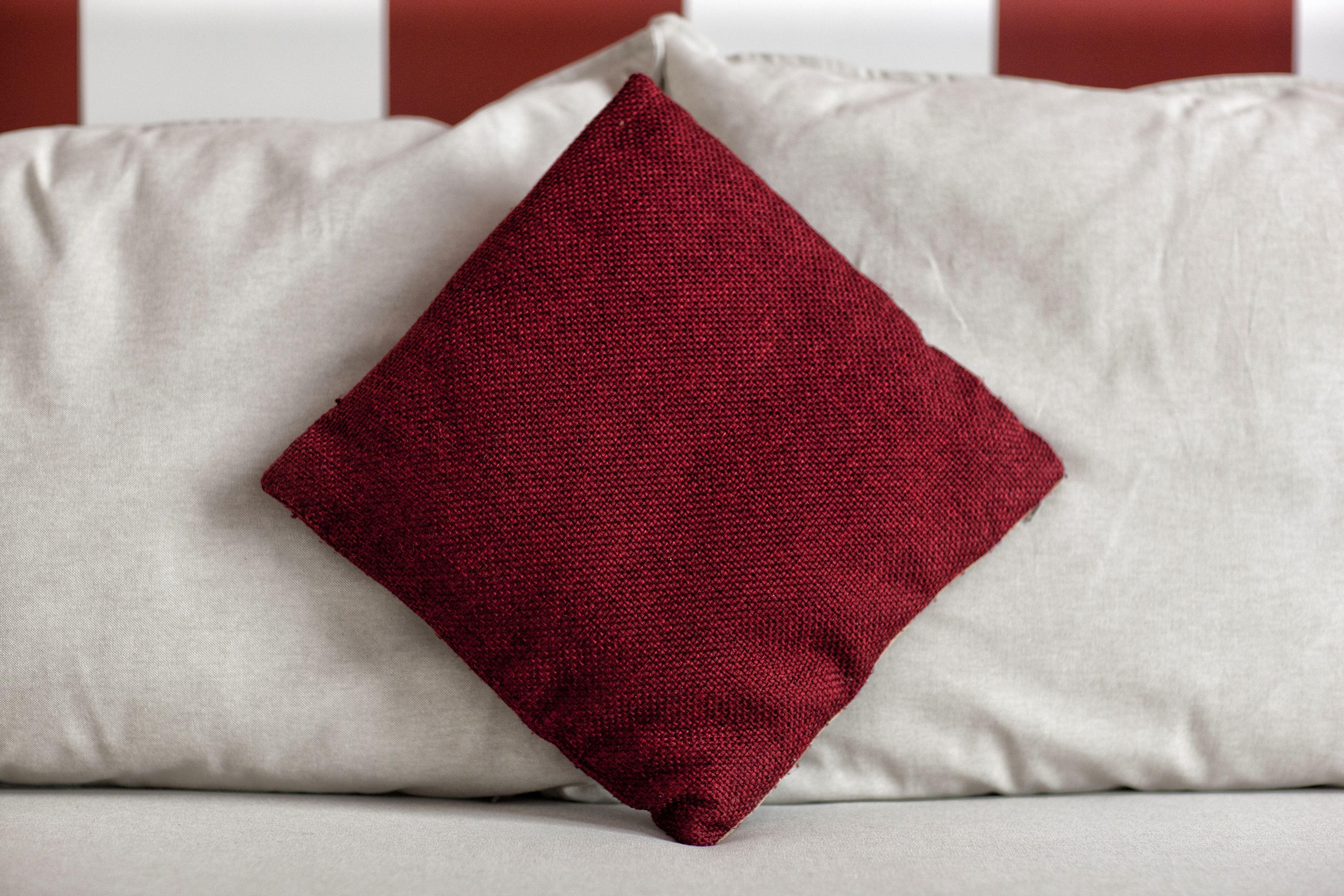 A pillow with a textured fabric and a contrasting color.