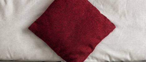 A pillow with a textured fabric and a contrasting color.
