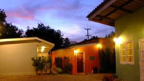 A two-story house with a red door and a small porch area. - Kaikatak Resort (Klaeng)