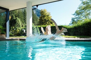 Una piscina al aire libre, sillones reclinables de piscina
