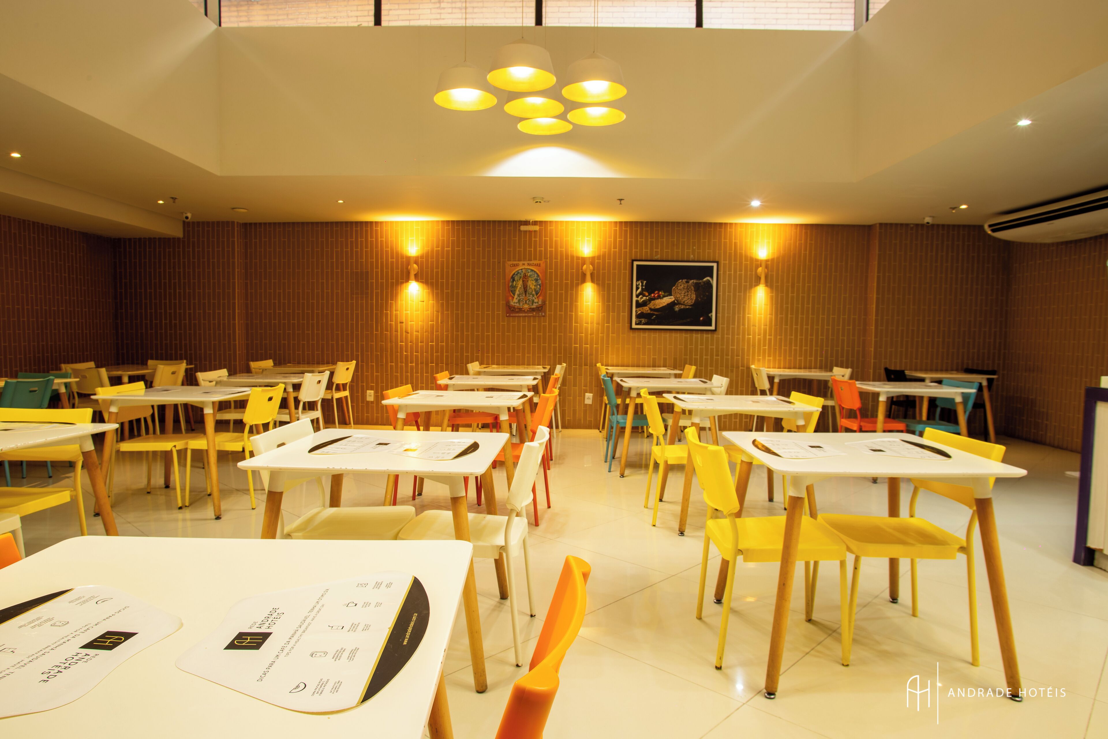 A dining area with multiple tables and chairs, arranged in rows.