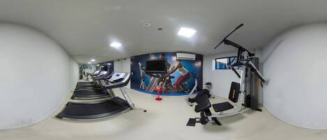 A gym with treadmills, a stationary bike, and weight machines.