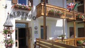 A building with a sign reading "ALBERGO" and a smaller sign "Lucio" inside. - Albergo Lucia (Tesero)