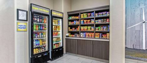 A vending area with two refrigerators labeled "Bright Side Market," stocked with beverages and snacks.