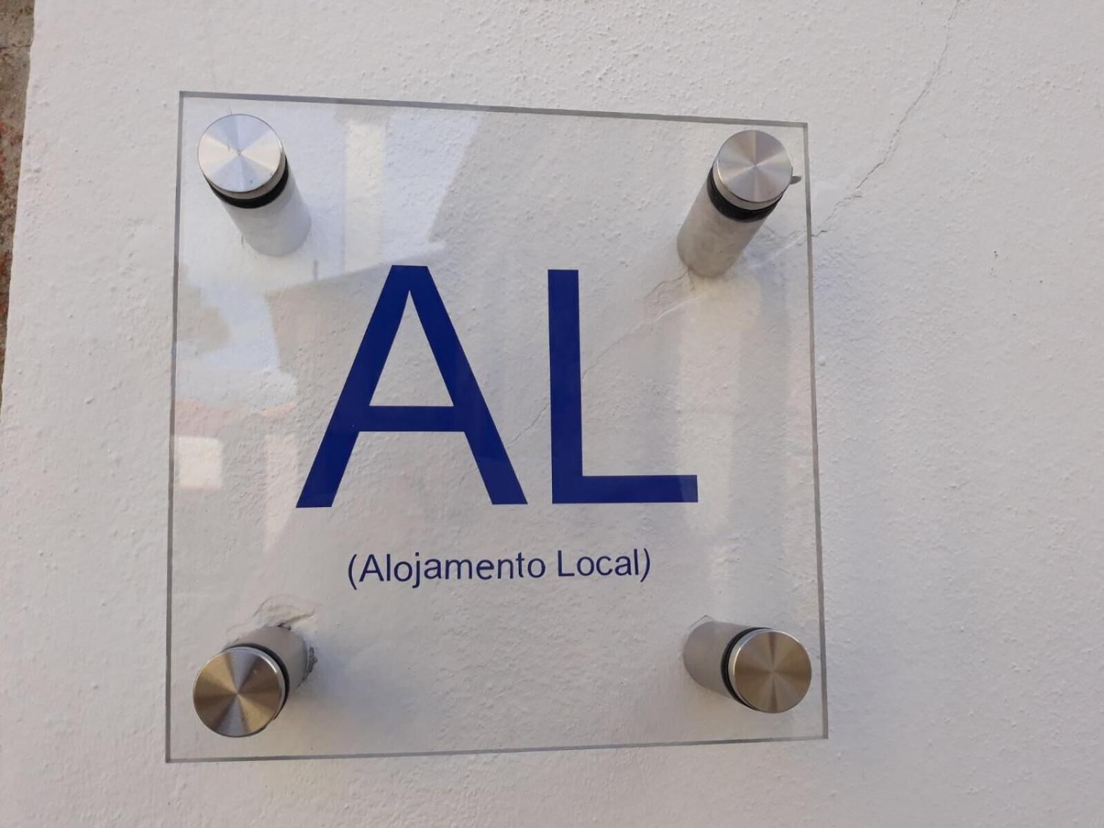 A sign with the letters "AL" and the text "(Alojamento Local)" indicating a local lodging facility.