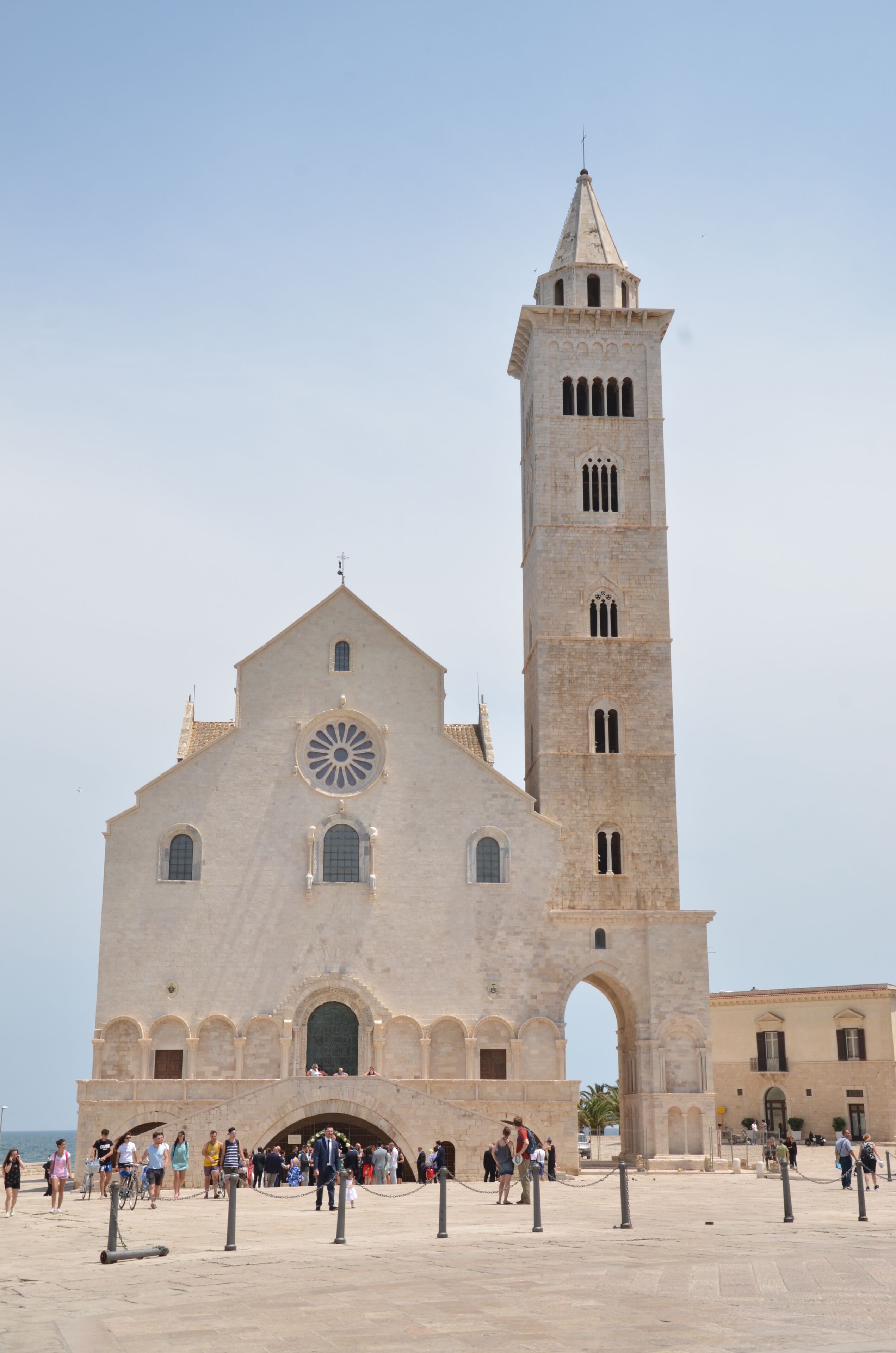 A historic church with a prominent tower and a large circular window.