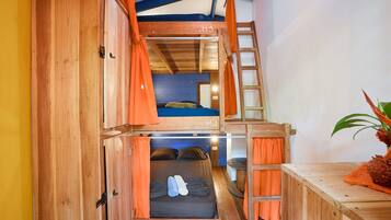 A compact, multi-level wooden room with bunk beds labeled H1, H2, and H3, a ladder, and a small table with a plant.