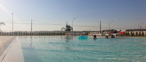 Seasonal outdoor pool, open 10:00 AM to 7:00 PM, sun loungers