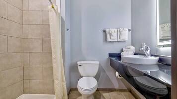 A bathroom with a bathtub, toilet, and sink.