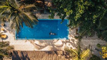 Surrounded by lush greenery, this pool offers a serene escape.
