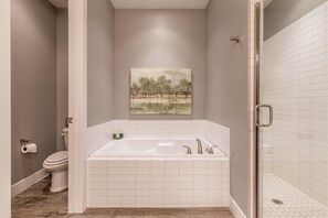 A bathroom with a bathtub, toilet, and shower. - Snow Canyon Sunrise (St. George)