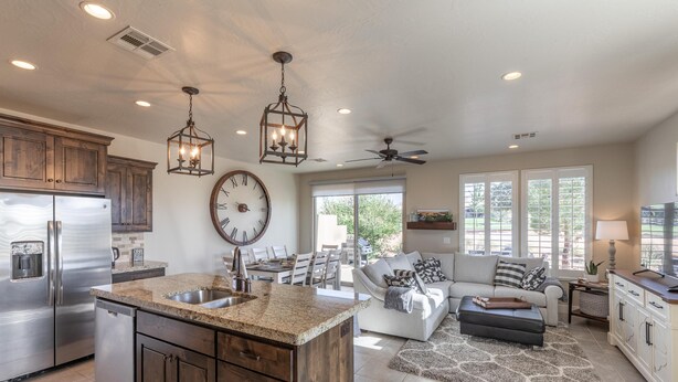 A spacious kitchen with granite countertops, stainless steel appliances, and wooden cabinets. - Life's Good (St. George)