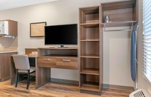 A modern kitchen with a built-in desk, a chair, and a television. - Extended Stay America Suites - Detroit - Rochester Hills (Rochester)