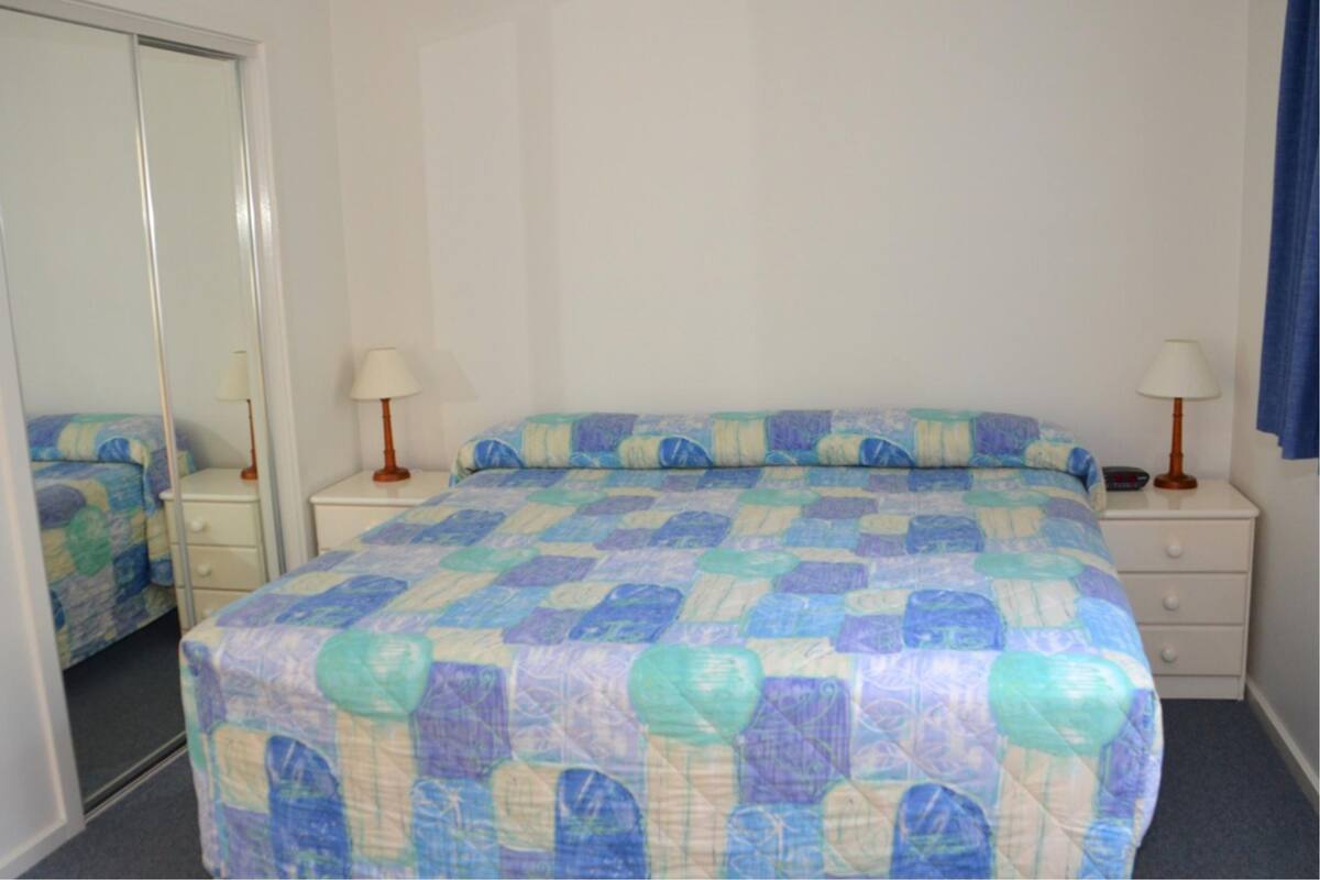 One Bedroom Unit | Desk, iron/ironing board, bed sheets