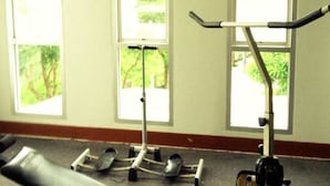 A gym with exercise equipment and large windows. - Amarin Grand Rayong (Rayong)