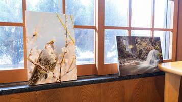 Two framed artworks on a window ledge.