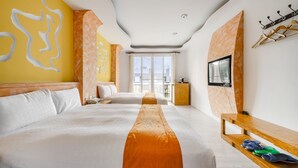 A hotel room with a large bed, a wooden bench, a TV, and a window with curtains. - Wei Yuan Hotel (Hengchun)