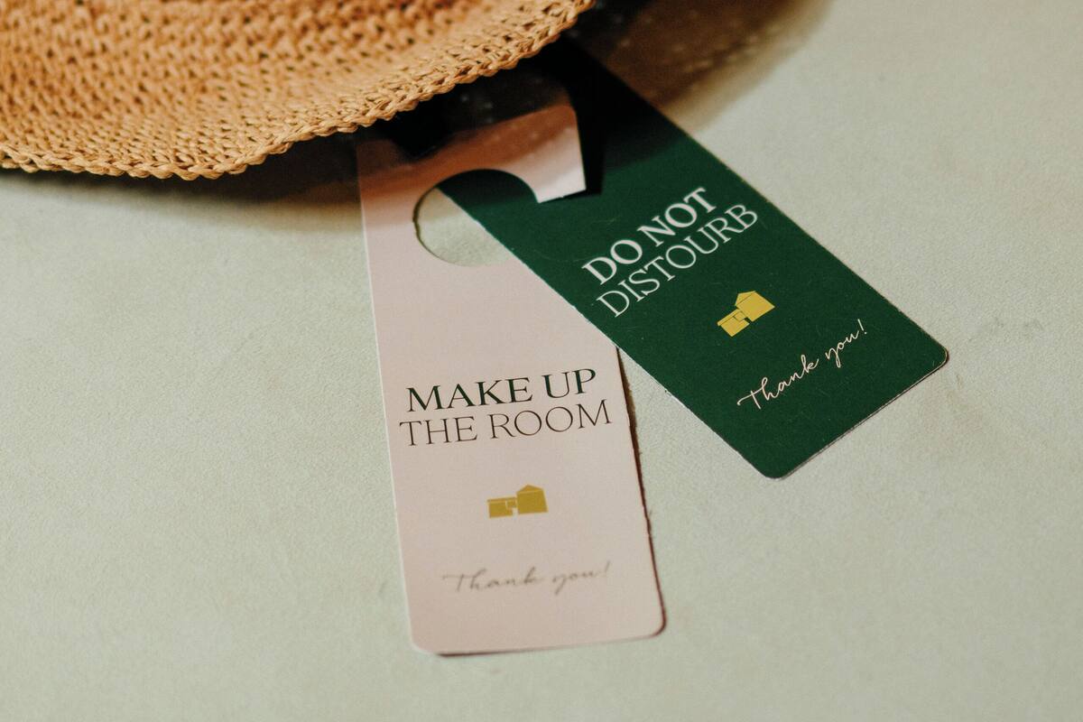 A straw hat and two tags with text.